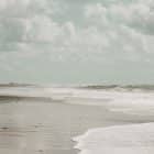 Sunlit beach with white sand and soft morning light